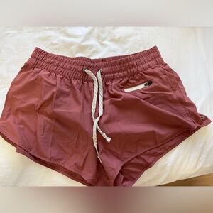 Vuori Women's Clementine Athletic Shorts in Pink / Red / Clay color